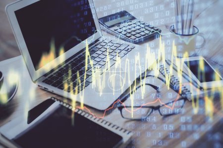 Photo for Stock market graph on background with desk and personal computer. Double exposure. Concept of financial analysis. - Royalty Free Image