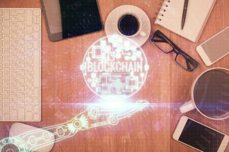Photo for Double exposure of blockchain theme hologram over table with phone. Top view. Crypto technology concept. - Royalty Free Image