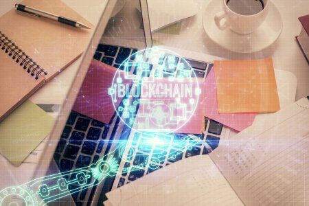 Photo for Blockchain theme hologram drawings over computer on the desktop background. Top view. Multi exposure. Concept of cryptoeconomy. - Royalty Free Image