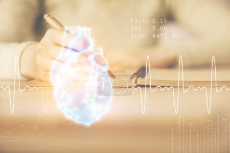 Photo for Heart hologram over woman's hands writing background. Concept of Medical education study. Double exposure - Royalty Free Image