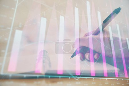 Photo for Forex graph on hand taking notes background. Concept of research. Multi exposure - Royalty Free Image
