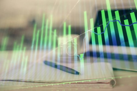 Photo for Double exposure of financial graph drawings and desk with open notebook background. Concept of forex market - Royalty Free Image