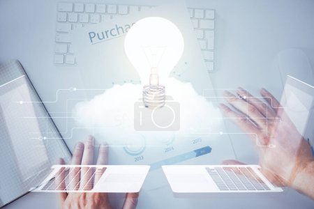 Photo for View of Bulb lamp idea concept icon on a futuristic interface with writing man's hand background. Double exposure. - Royalty Free Image
