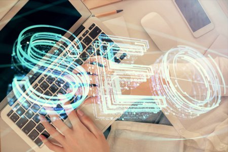 Photo for Double exposure of woman hands working on computer and SEO hologram drawing. Top View. Search optimization concept. - Royalty Free Image
