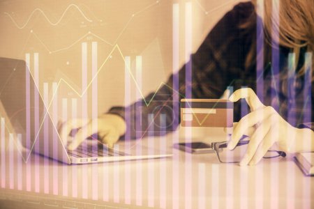 Photo for Double exposure of woman on-line shopping holding a credit card and financial graph drawing. Stock market E-commerce concept. - Royalty Free Image
