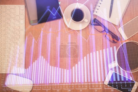 Photo for Double exposure of financial chart hologram over desktop with phone. Top view. Mobile trade platform concept. - Royalty Free Image