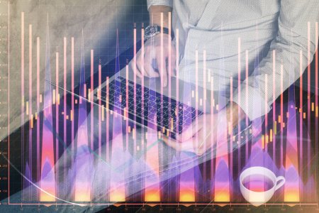 Photo for Forex graph with businessman working on computer in office on background. Concept of analysis. Double exposure. - Royalty Free Image