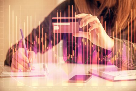 Photo for Double exposure of woman on-line shopping holding a credit card and financial graph drawing. Stock market E-commerce concept. - Royalty Free Image