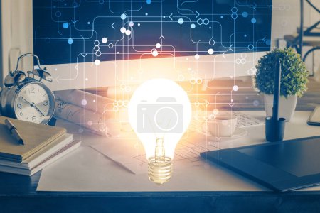 Photo for Computer on desktop in office with bulb icon hologram. Double exposure. Concept of idea. - Royalty Free Image