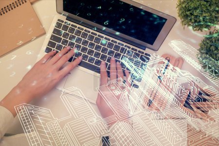 Photo for Double exposure of woman hands working on computer and buildings construction hologram drawing. Top View. smart city concept. - Royalty Free Image