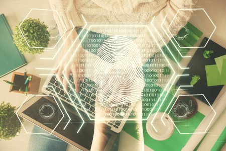Photo for Double exposure of woman hands working on computer and fingerprint hologram drawing. Top View. Digital Security concept. - Royalty Free Image