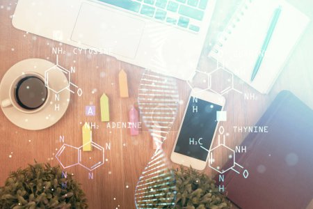 Photo for Double exposure of DNA drawing over table with phone. Top view. Science education concept. - Royalty Free Image