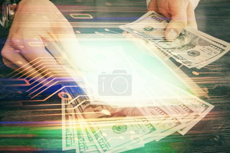 Photo for Double exposure of technology drawing hologram and us dollars bills and man hands. Data concept - Royalty Free Image