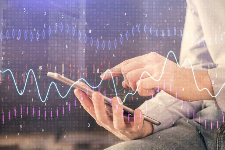 Photo for Double exposure of man's hands holding and using a digital device and forex graph drawing. Financial market concept. - Royalty Free Image
