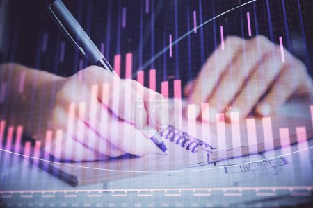 Photo for Forex graph on hand taking notes background. Concept of research. Double exposure - Royalty Free Image