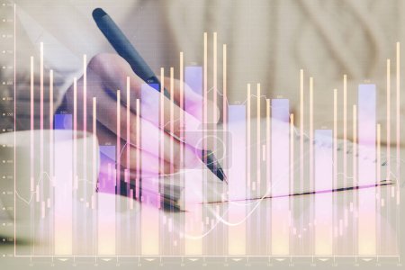 Photo for Forex chart displayed on woman's hand taking notes background. Concept of research. Double exposure - Royalty Free Image