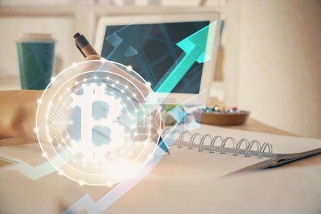 Photo for Cryptocurrency hologram, bitcoin, ico theme over hands taking notes background. Concept of blockchain. Multi exposure - Royalty Free Image