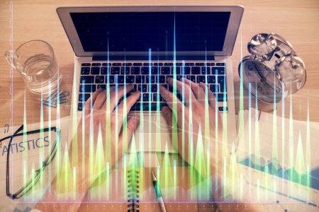 Photo for Double exposure of man's hands typing over laptop keyboard and forex chart hologram drawing. Top view. Financial markets concept. - Royalty Free Image