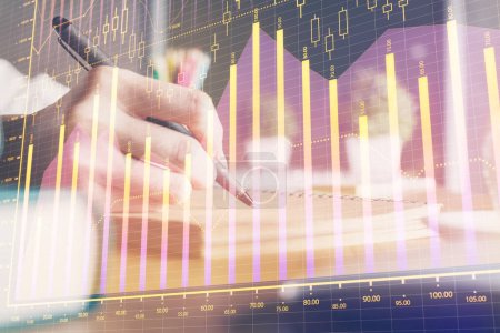 Photo for Financial forex charts displayed on woman's hand taking notes background. Concept of research. Double exposure - Royalty Free Image