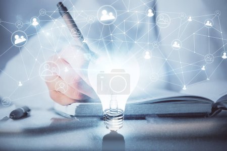 Photo for Bulb hologram over hands taking notes background. Concept of idea. Double exposure - Royalty Free Image
