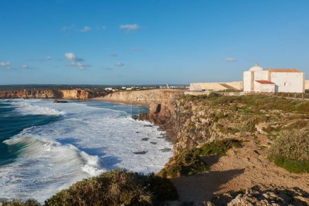 Photo for Sagres Fortress on the edge of the cliffs. Stormy ocean and Praia do Tonel in the background. Portugal - Royalty Free Image