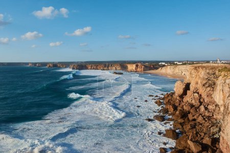 Photo for Typical Portuguese landscape - huge cliffs and giant stones washed by the waves of the Atlantic Ocean near Sagres, Portugal - Royalty Free Image