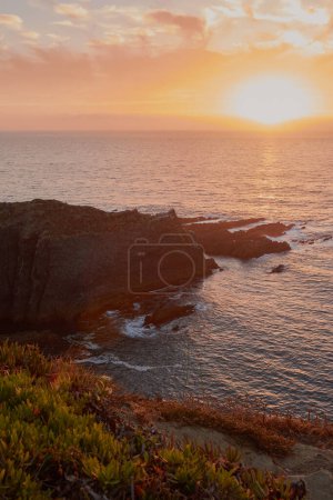 Photo for Amazing view of the sun setting over the Atlantic Ocean. West of the Portugal seashore - Royalty Free Image
