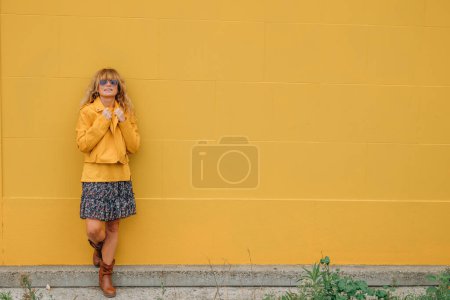 Photo for Middle aged woman isolated on yellow wall - Royalty Free Image