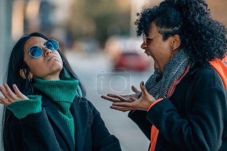 Photo for Friends or girls in the street arguing angry - Royalty Free Image