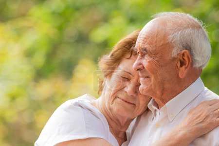 senior couple holding each other outdoors