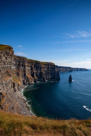 Photo for On the very edge of the Cliffs of Moher. The sea cliffs located at the southwestern edge of the Burren region in County Clare, Ireland. They run for about 14 kilometres. - Royalty Free Image