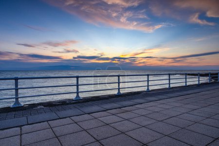 End of the day on the promenade in Aberystwyth. It is a seaside resort with a long promenade, and is situated on the Welsh coast.