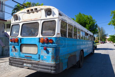 Photo for Havana, Cuba - January 2,2017: Typical old school bus parked in front of old building on the Havana street. - Royalty Free Image