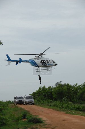 Photo for MAN BODY HANGING FROM HELICOPTER 5th Dec 2022 Hyderabad India - Royalty Free Image