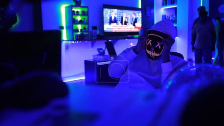 Photo for Hacker With Led Mask Working On Computers - Royalty Free Image