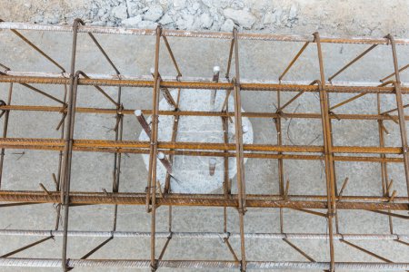 Photo for Monolithic foundation with metal reinforcement. Reinforcement construction mesh. Concrete pile foundation after completed for new construction site. The construction tool for monolithic works. - Royalty Free Image