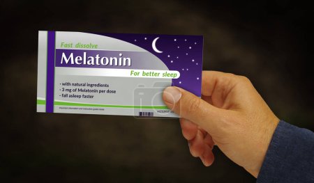 Photo for Melatonin tablets box in hand. Medical sleeplessness help and insomnia remedy pills pack factory. Abstract concept 3d rendering illustration. - Royalty Free Image
