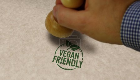Vegano sello amistoso y la mano de estampación. Concepto de comida orgánica vegetariana.