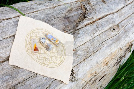Three healing crystal towers on a crystal grid cloth using sacred flower of life geometry. 