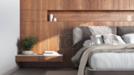 Foto de Blurred background, cozy bedroom close up. Wooden headboard. Velvet bed, bedding, pillows and carpet. Modern minimalist interior design - Imagen libre de derechos