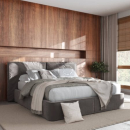 Foto de Blurred background, cozy bedroom close up. Wooden headboard. Velvet bed, bedding, pillows and carpet. Contemporary minimalist interior design - Imagen libre de derechos