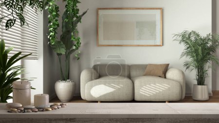 Wooden vintage table top or shelf with candles and pebbles, zen mood, over modern living room with fabric sofa and frame mockup, interior design concept idea
