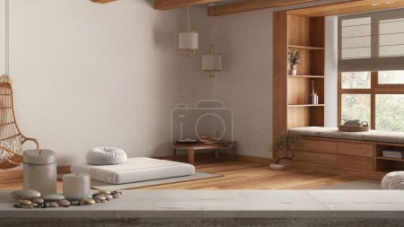 Photo for Wooden vintage table top or shelf with candles and pebbles, zen mood, over minimal meditation room with pillows and tatami mats, architecture interior design - Royalty Free Image
