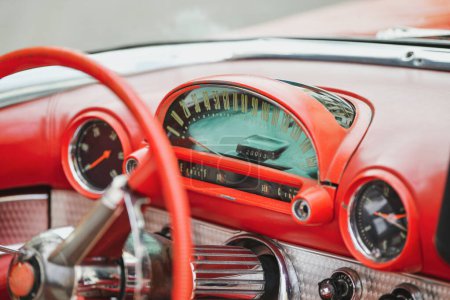 Interior of red vintage car and speedometer