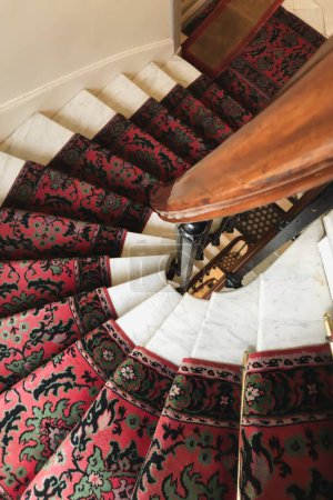 Vintage carpet on a swirling staircase in an apartment in Paris France