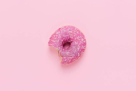 Photo for Top view of one pink donut on a pink background, copy space - Royalty Free Image