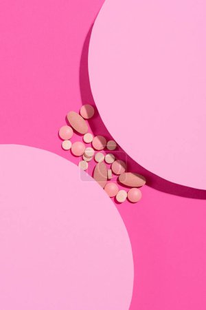Photo for Creative layout with pills on pastel two tone pink art background. Minimal pharmacy medical treatment concept. Top view, flat lay, copy space - Royalty Free Image