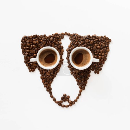Photo for Funny dog made of roasted coffee beans and two cups on white background. Creative concept photo of Jack Russell Terrier dog made of roasted coffee beans. Top view, copy space - Royalty Free Image