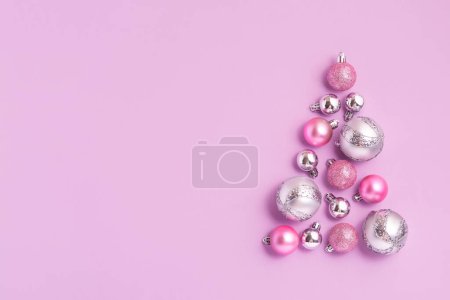 Photo for Christmas composition of Christmas tree made of pink ball decoration on pink background. New Year sale card, copy space - Royalty Free Image