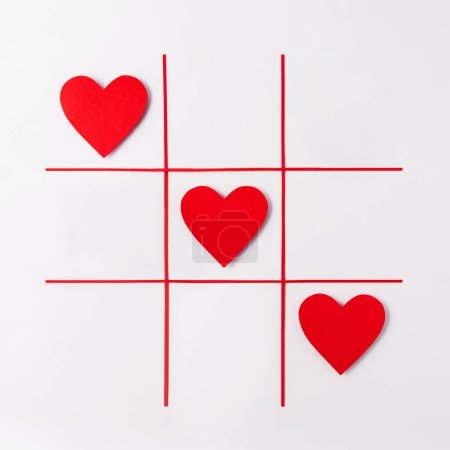 Photo for Red hearts on white background. Creative concept idea with red hearts on tic tac toe game. Valentines day concept, top view - Royalty Free Image